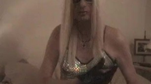 Crossdresser Blonde Ariane in Sparkling Silver Dress and Showing Ass